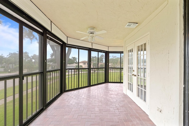 unfurnished sunroom featuring french doors and ceiling fan