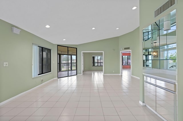 tiled empty room with vaulted ceiling