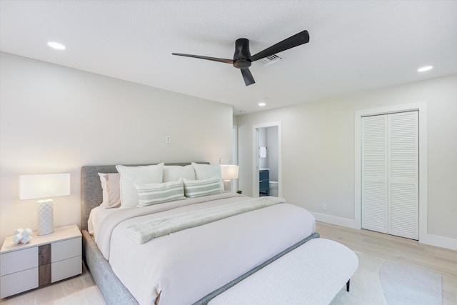 bedroom with ensuite bath, light hardwood / wood-style flooring, a closet, and ceiling fan