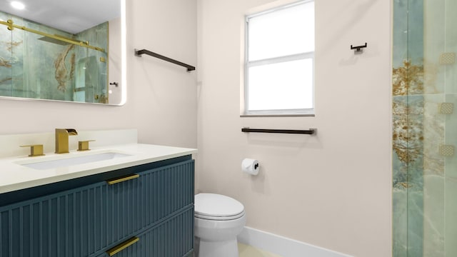 bathroom with vanity, toilet, and an enclosed shower