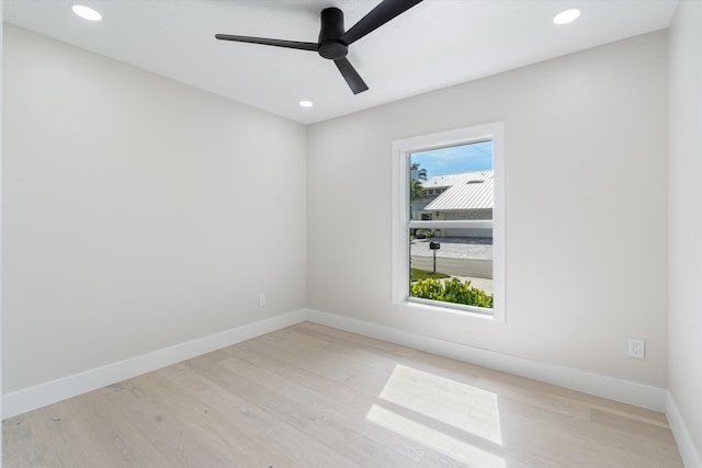 unfurnished room with ceiling fan and light wood-type flooring