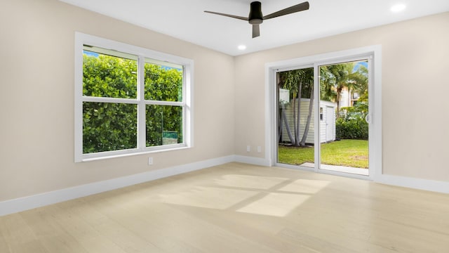 spare room with light hardwood / wood-style floors and ceiling fan