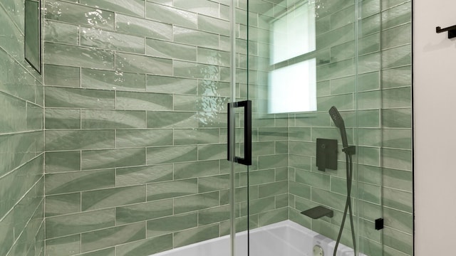 bathroom featuring shower / bath combination with glass door