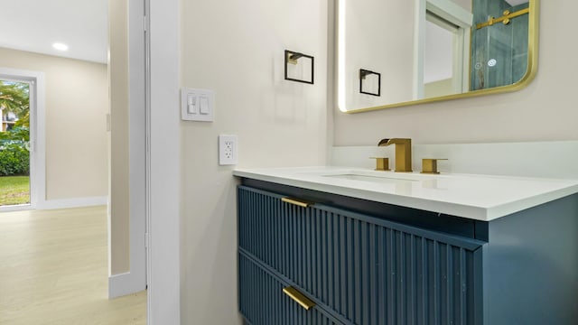 bathroom with vanity and hardwood / wood-style floors