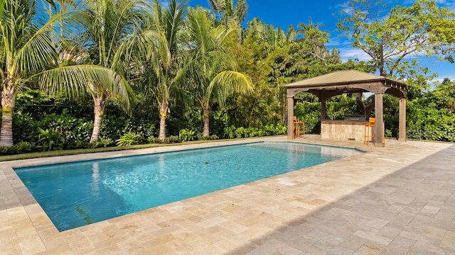 view of swimming pool featuring an outdoor bar and a gazebo