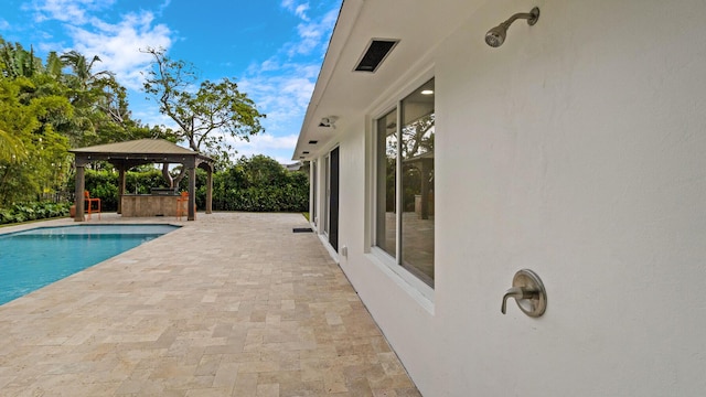 view of pool featuring a gazebo and a patio area