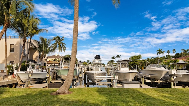 view of dock with a lawn