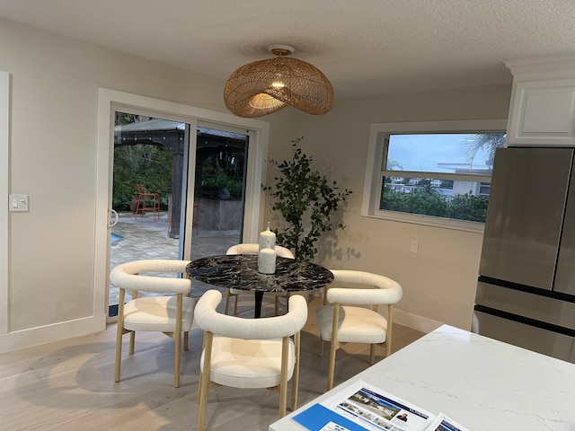 dining area featuring light wood-type flooring