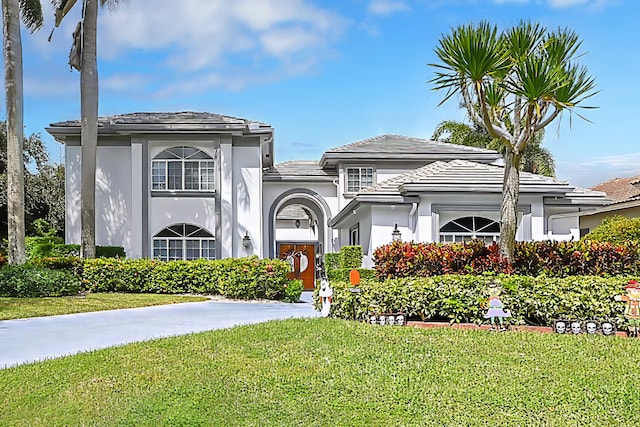 mediterranean / spanish house with a front lawn