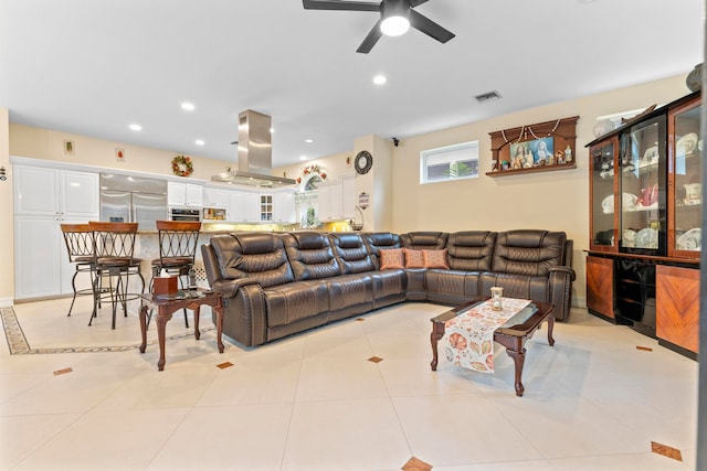 tiled living room featuring ceiling fan