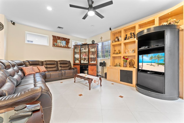 tiled living room featuring ceiling fan