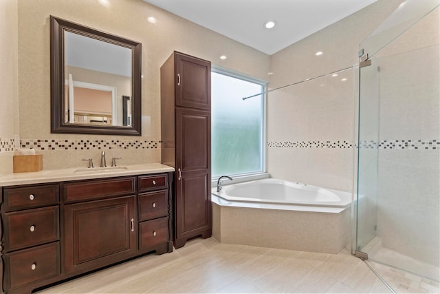 bathroom featuring vanity and shower with separate bathtub