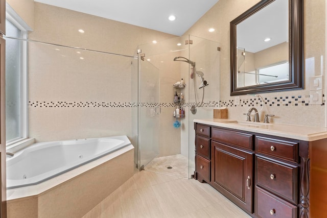 bathroom featuring vanity, tile patterned floors, tile walls, and separate shower and tub