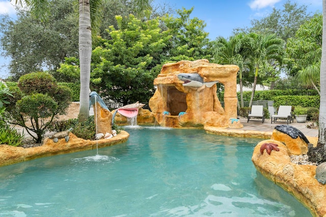 view of swimming pool featuring a patio and a water slide