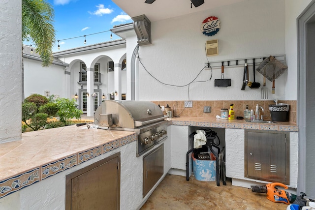 view of patio featuring french doors, sink, a grill, and an outdoor kitchen