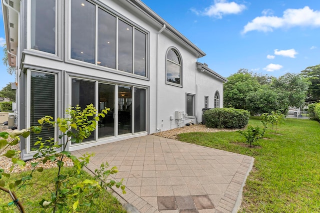 back of house featuring a yard and a patio