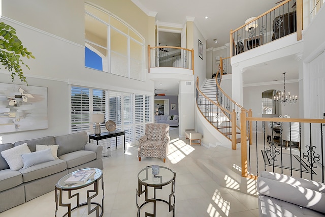 tiled living room featuring a high ceiling, crown molding, and ceiling fan with notable chandelier