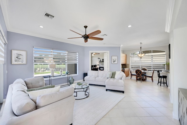 living room featuring ceiling fan, ornamental molding, and light tile patterned flooring