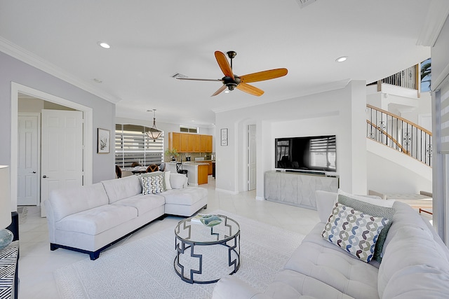 living room featuring crown molding, light tile patterned floors, and ceiling fan with notable chandelier