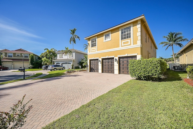 view of front facade featuring a front yard and a garage