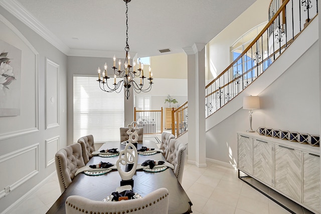 dining space with an inviting chandelier, crown molding, and light tile patterned flooring