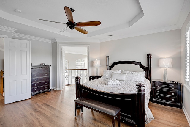 bedroom featuring light hardwood / wood-style flooring, multiple windows, and ceiling fan