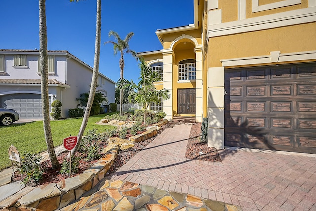 exterior space with a garage and a lawn