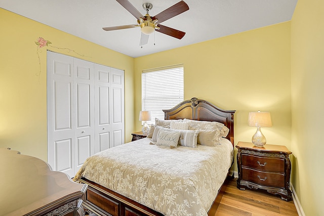 bedroom featuring a closet, light hardwood / wood-style floors, and ceiling fan