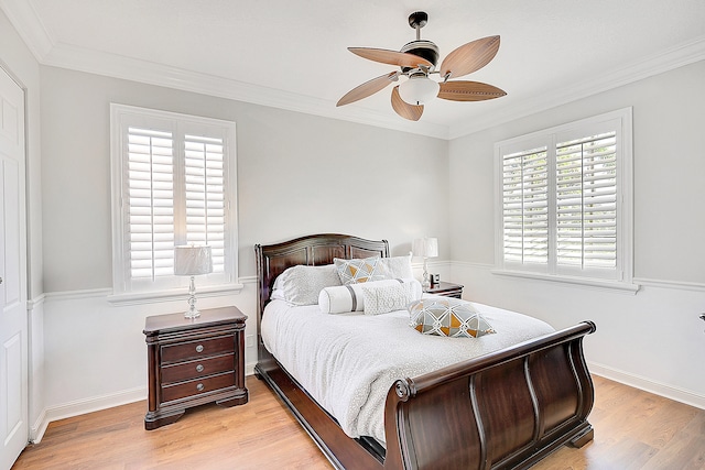 bedroom featuring ornamental molding, light hardwood / wood-style flooring, and ceiling fan