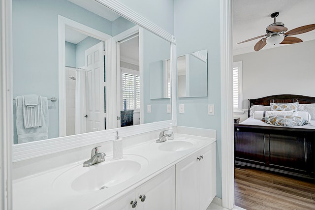 bathroom with vanity, ornamental molding, hardwood / wood-style flooring, and ceiling fan