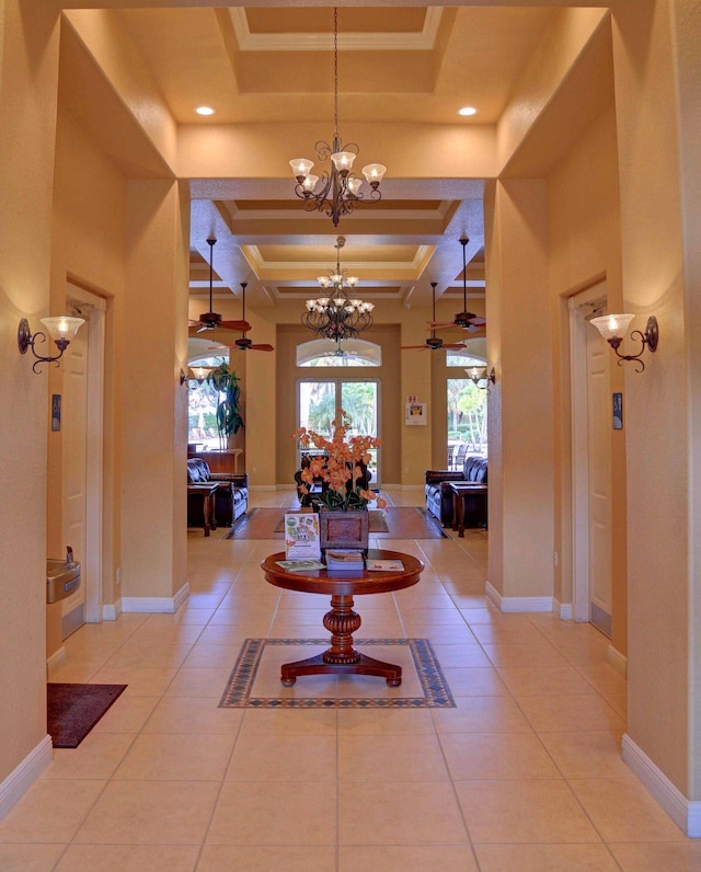 corridor featuring beam ceiling, tile patterned floors, coffered ceiling, and a raised ceiling