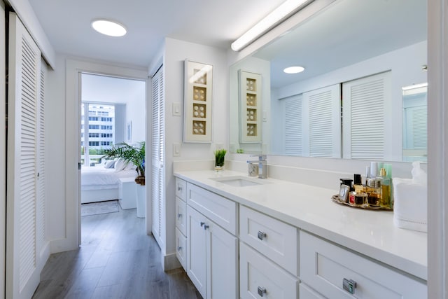 bathroom with vanity and hardwood / wood-style flooring