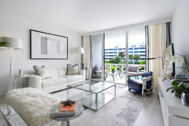 living room with expansive windows and hardwood / wood-style flooring