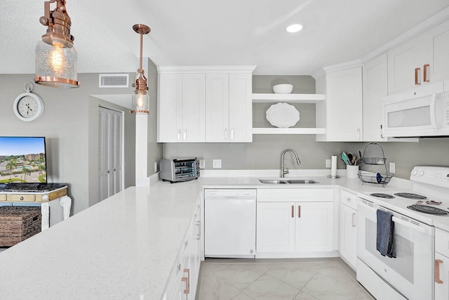 kitchen featuring white appliances, white cabinetry, sink, hanging light fixtures, and a textured ceiling