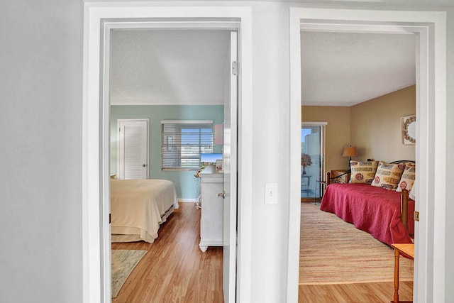 bedroom featuring a textured ceiling and light hardwood / wood-style flooring