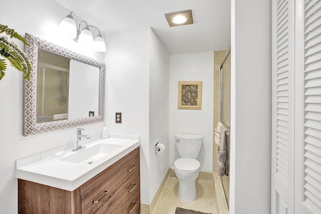 bathroom featuring vanity, tile patterned flooring, toilet, and an enclosed shower