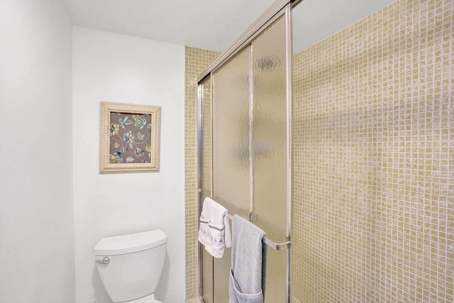 bathroom with an enclosed shower and toilet