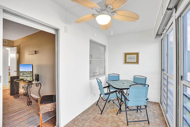 sunroom / solarium featuring ceiling fan