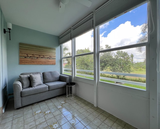 sunroom featuring ceiling fan