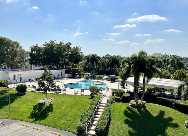 view of pool with a yard and a patio area