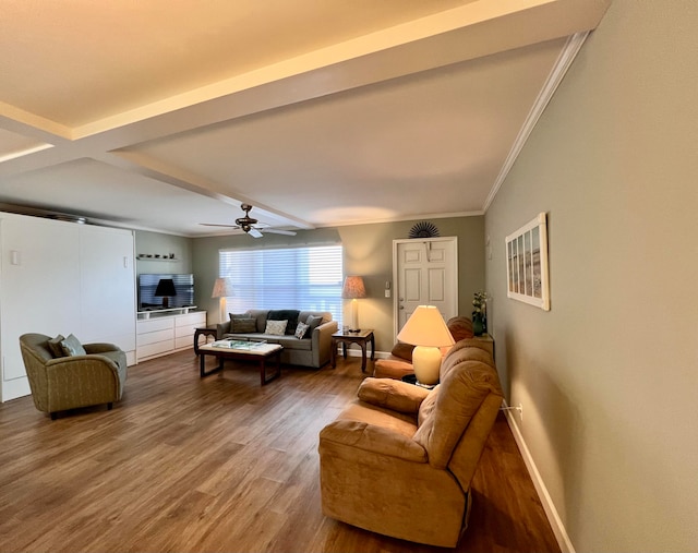 living room with ceiling fan, ornamental molding, beamed ceiling, and hardwood / wood-style floors