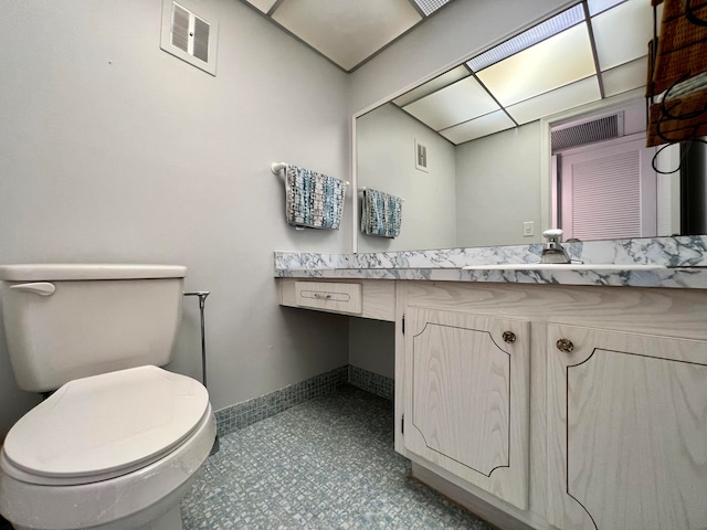 bathroom with vanity, toilet, and tile patterned floors