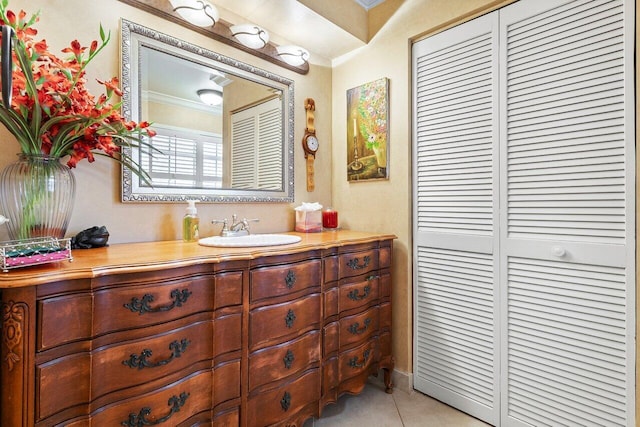 bathroom featuring vanity, crown molding, and tile patterned floors