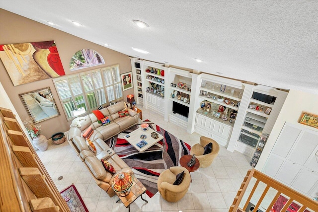 living room featuring a textured ceiling and light tile patterned floors