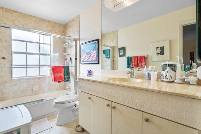 full bathroom with vanity, toilet, tile patterned flooring, and bath / shower combo with glass door