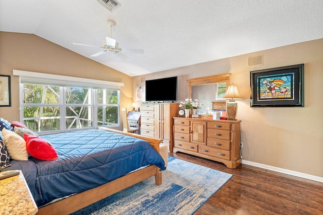 bedroom featuring ceiling fan, a textured ceiling, lofted ceiling, and dark hardwood / wood-style flooring