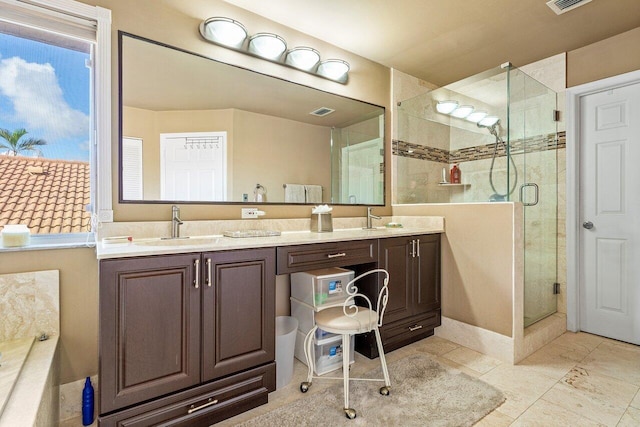 bathroom with a shower with door and vanity