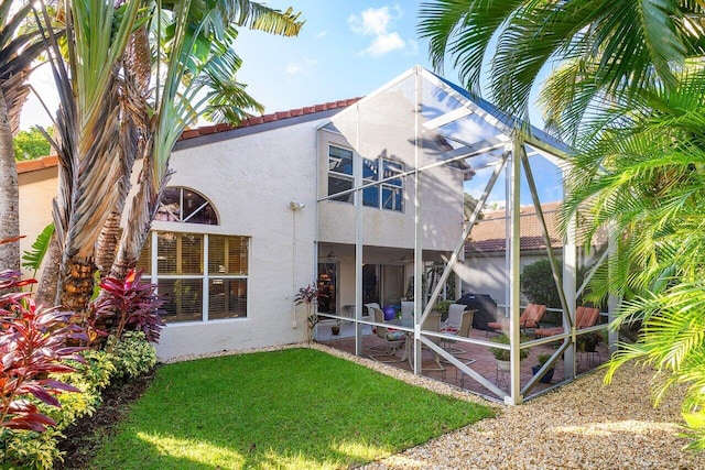 rear view of house featuring a yard and a patio area