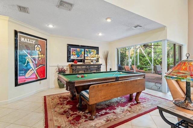 rec room with pool table, crown molding, a textured ceiling, and light tile patterned flooring