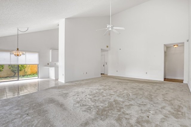 unfurnished living room with light carpet, a textured ceiling, high vaulted ceiling, and ceiling fan